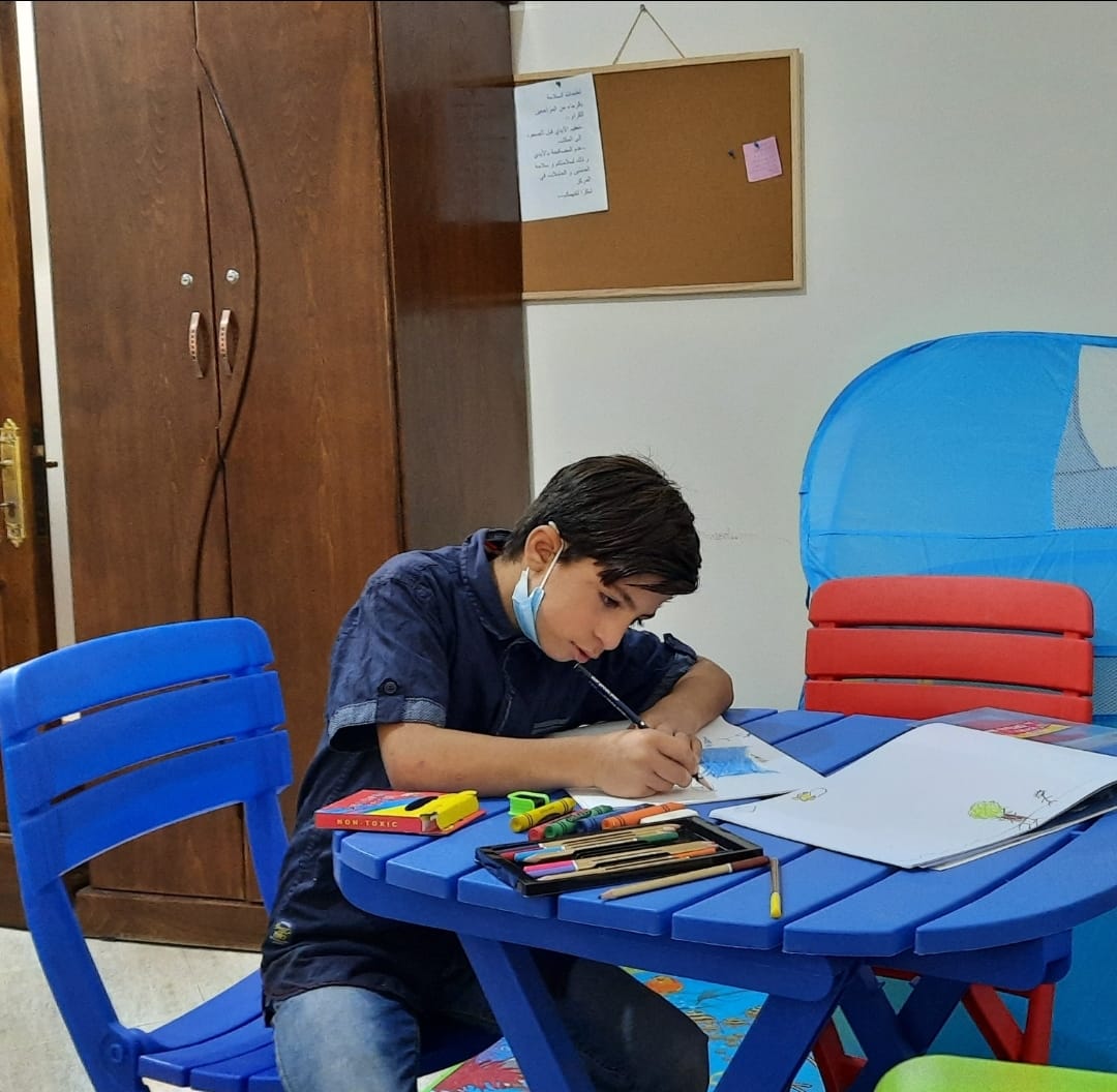 photo showing a boy drawing