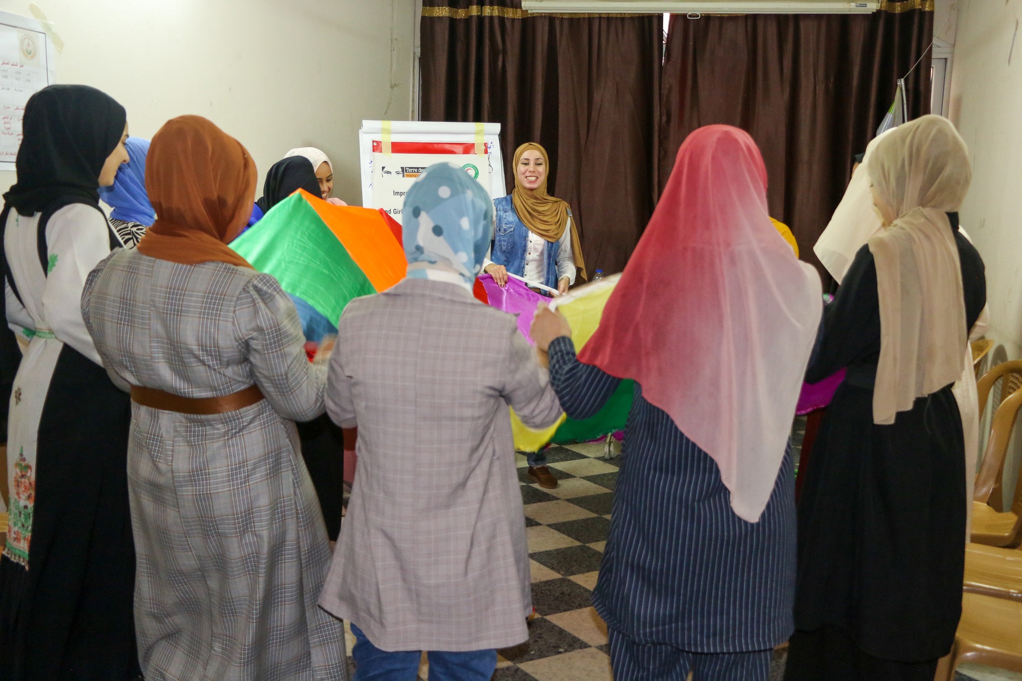 photo of girls standing with the colourful canvas